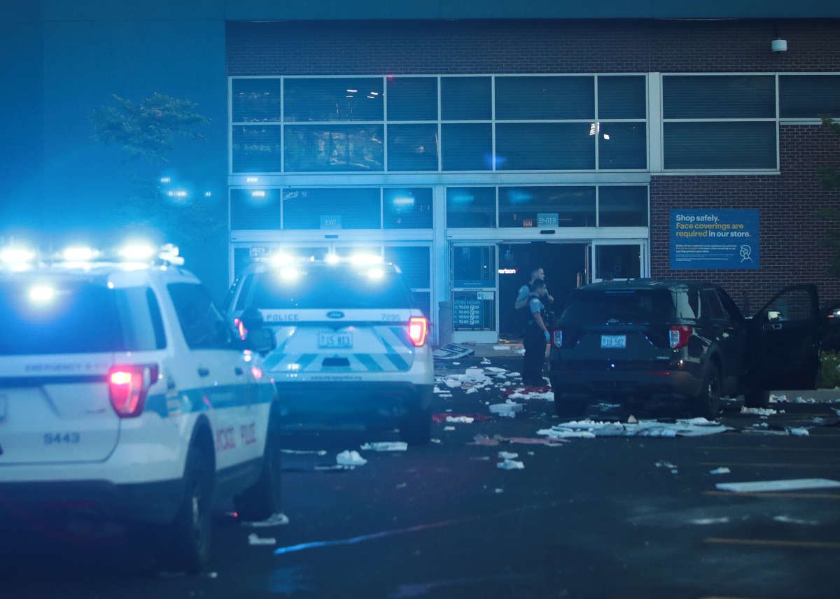 Police officers inspect a damaged Best Buy store on August 10, 2020, in Chicago, Illinois.