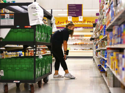 Clerk Ali Hutchings looks for an item to fulfill a grocery delivery order at Stop and Shop in Brockton, Massachusetts, on August 17, 2020.