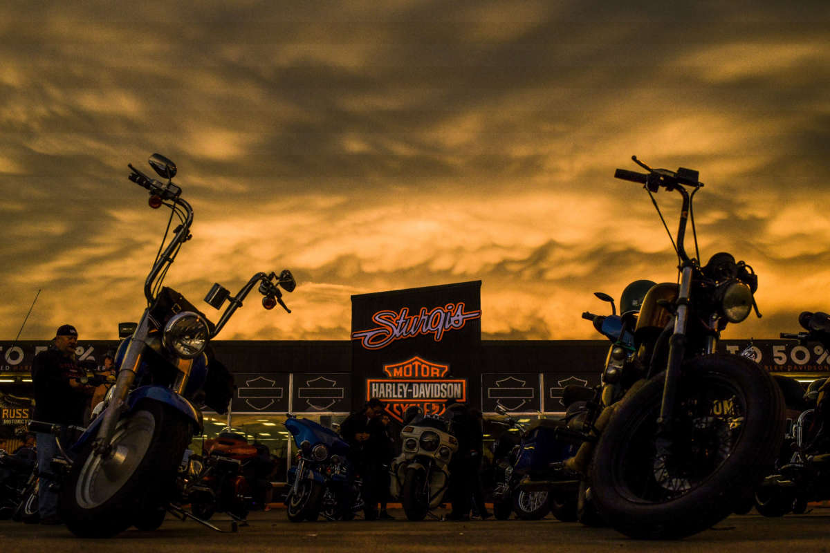 The sunset lights up storm clouds over the Sturgis Harley-Davidson dealership during the 80th Annual Sturgis Motorcycle Rally in Sturgis, South Dakota, on August 8, 2020.