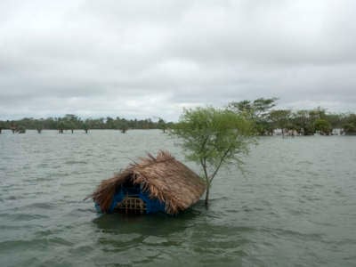 A house sits submerged in floodwaters