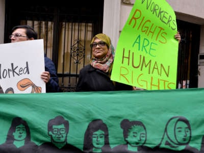 A group supporting domestic workers' rights demonstrate across the street from the Indian Consulate General, December 20, 2013, in New York City.