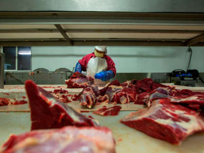 A butcher chops up beef at Jones Meat & Food Services in Rigby, Idaho, May 26, 2020.