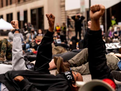 People stage a die in outside the Hennepin County Family Justice Center on September 11, 2020, in Minneapolis, Minnesota.