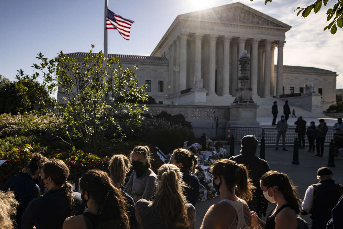 Members of the Georgetown University Women's Rowing Team visit a makeshift memorial in honor of Supreme Court Justice Ruth Bader Ginsburg in front of the Supreme Court on September 19, 2020, in Washington, D.C.