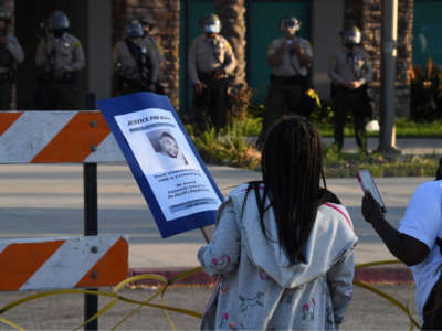 Protesters stand facing the South L.A. Sheriff's Station on September 1, 2020, in Los Angeles, as protestors demand justice for Dijon Kizzee, who was shot and killed the previous day by Los Angeles Sheriff's Deputies.