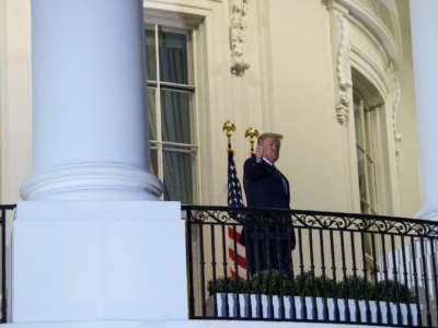 President Trump gives a thumbs up from the Truman Balcony upon his return to the White House from Walter Reed Medical Center, where he underwent treatment for COVID-19, in Washington, D.C, on October 5, 2020.