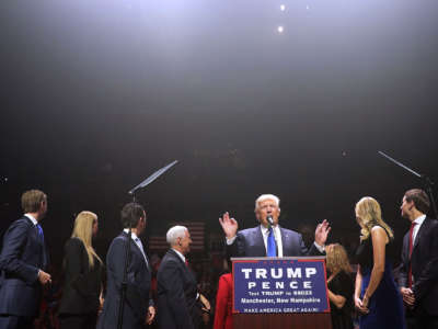 Then-presidential nominee Donald Trump is joined on stage by his family and Mike Pence during a campaign rally at the SNHU Arena November 7, 2016, in Manchester, New Hampshire.