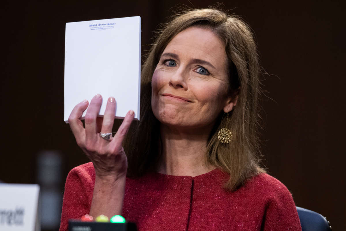 Supreme Court justice nominee Amy Coney Barrett holds up her notepad at the request of Sen. John Cornyn on the second day of her Senate Judiciary Committee confirmation hearing in the Hart Senate Office Building on October 13, 2020.