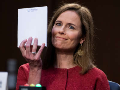 Supreme Court justice nominee Amy Coney Barrett holds up her notepad at the request of Sen. John Cornyn on the second day of her Senate Judiciary Committee confirmation hearing in the Hart Senate Office Building on October 13, 2020.