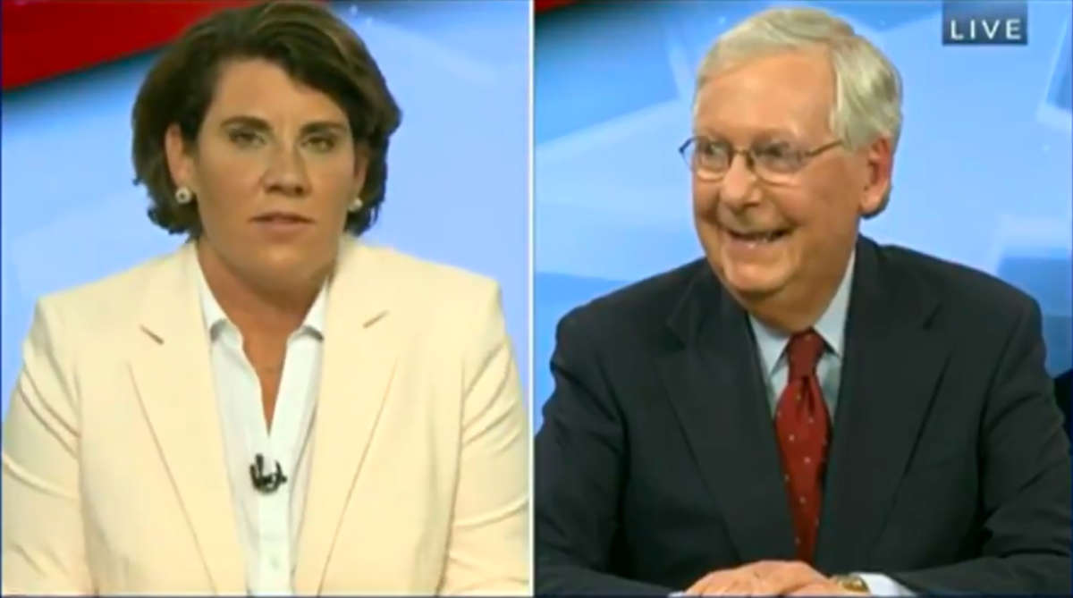 Mitch McConnell laughs as Amy McGrath speaks during their debate on October 13, 2020.