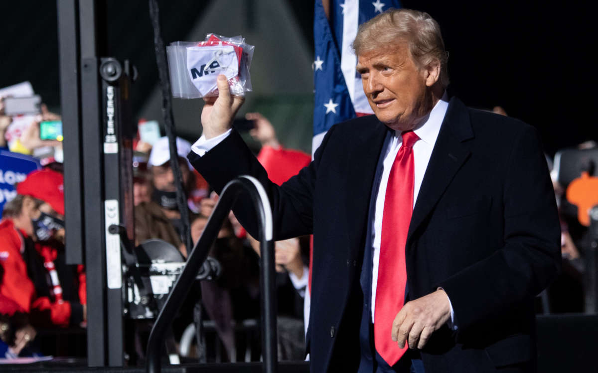 President Trump holds masks as he arrives for a rally at John Murtha Johnstown-Cambria County Airport in Johnstown, Pennsylvania, October 13, 2020.