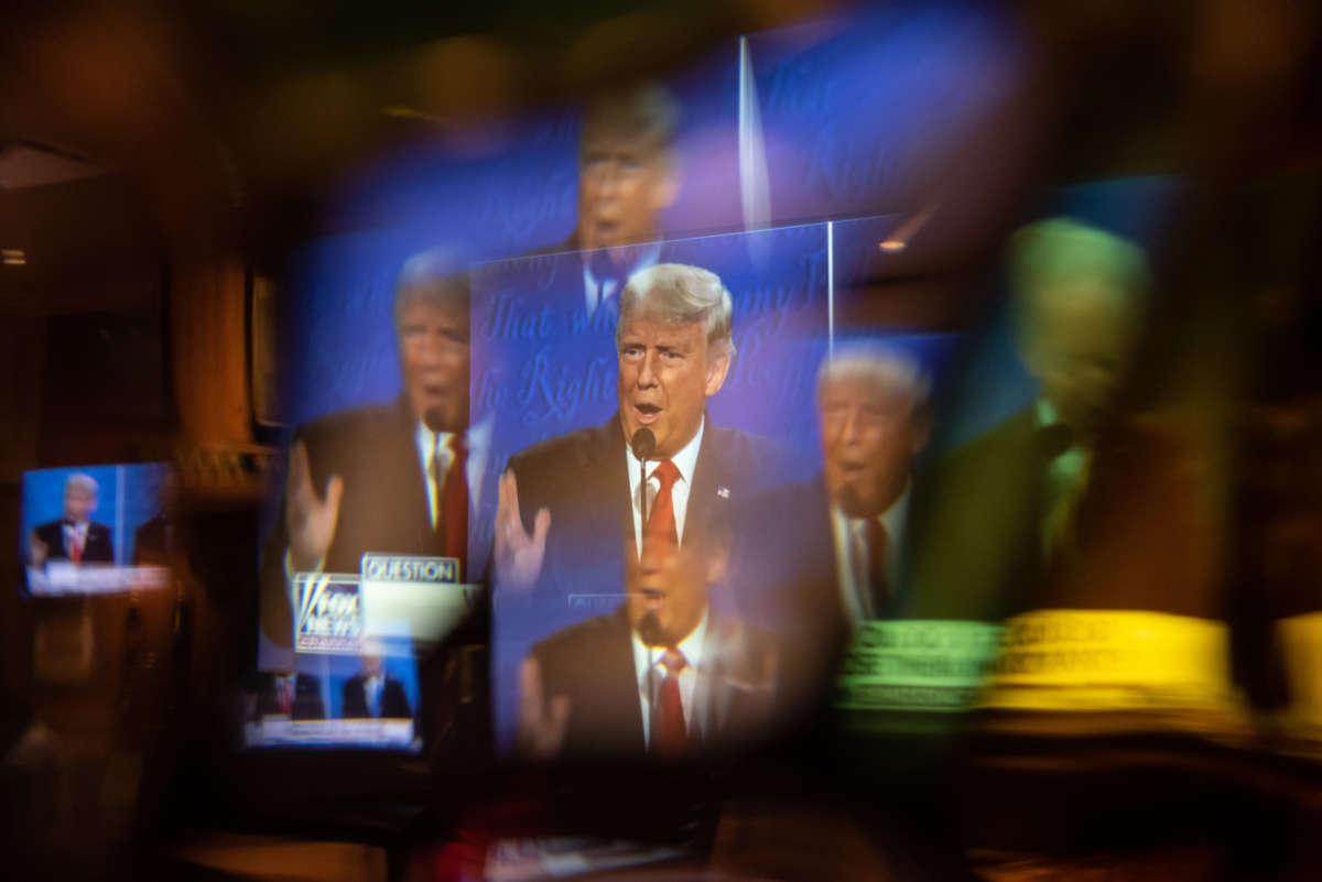 President Trump is seen on screen through a window at a watch party for the final presidential debate with former Vice President Joe Biden on October 22, 2020, in San Antonio, Texas.