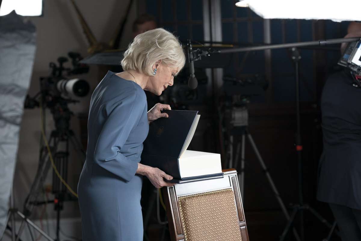 Leslie Stahl, in a photo tweeted by President Trump on October 21, 2020, looks into the large book presented to her by White House Press Secretary Kayleigh McEnany.