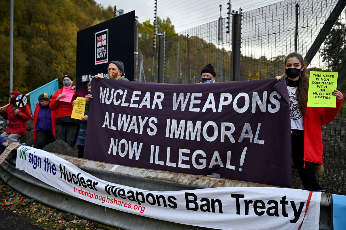 Anti-nuclear campaigners hold banners and placards outside Her Majesty's Naval Base, Clyde, on October 25, 2020, in Faslane, Scotland. Demonstrators were there to mark the announcement of an international treaty banning nuclear weapons which has been ratified by a 50th country, the UN has said.