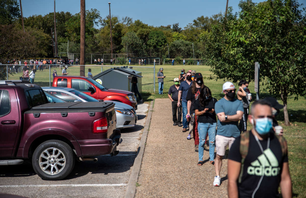 Voters wait in line at a polling location on October 13, 2020, in Austin, Texas.