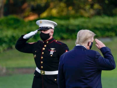 Donald Trump salutes as he prepares to board Marine One for Walter Reed National Military Medical Center on the South Lawn of the White House on October 2, 2020, in Washington, D.C.