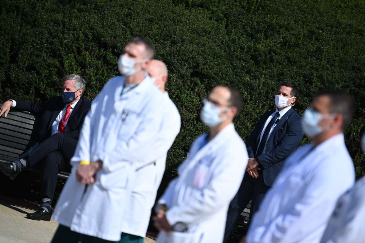 White House Chief of Staff Mark Meadows (left) listens as White House physician Sean Conley answers questions surrounded by other doctors, during an update on the condition of President Donald Trump, on October 4, 2020, at Walter Reed National Military Medical Center in Bethesda, Maryland.