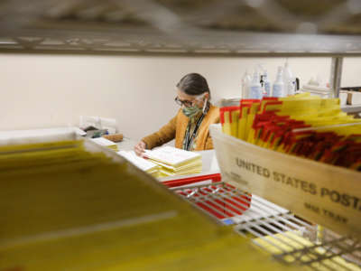 Mail-in ballots sit in containers from the U.S. Postal Service waiting to be processed by election workers at the Salt Lake County election office in Salt Lake City, Utah, on October 29, 2020.