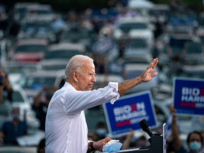 Democratic presidential nominee Joe Biden waves to supporters as he finishes speaking during a drive-in campaign rally in the parking lot of Cellairis Ampitheatre on October 27, 2020, in Atlanta, Georgia.