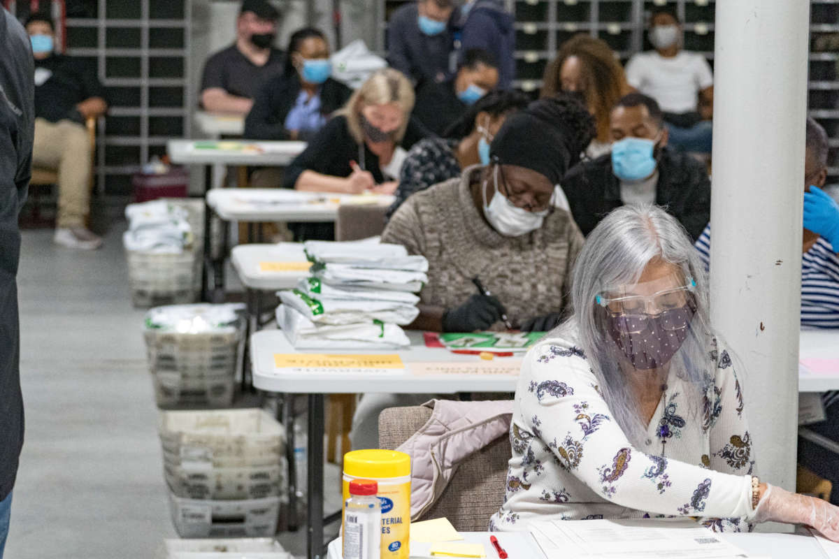 Gwinnett County election workers handle ballots as part of the recount for the 2020 presidential election at the Beauty P. Baldwin Voter Registrations and Elections Building on November 16, 2020, in Lawrenceville, Georgia.