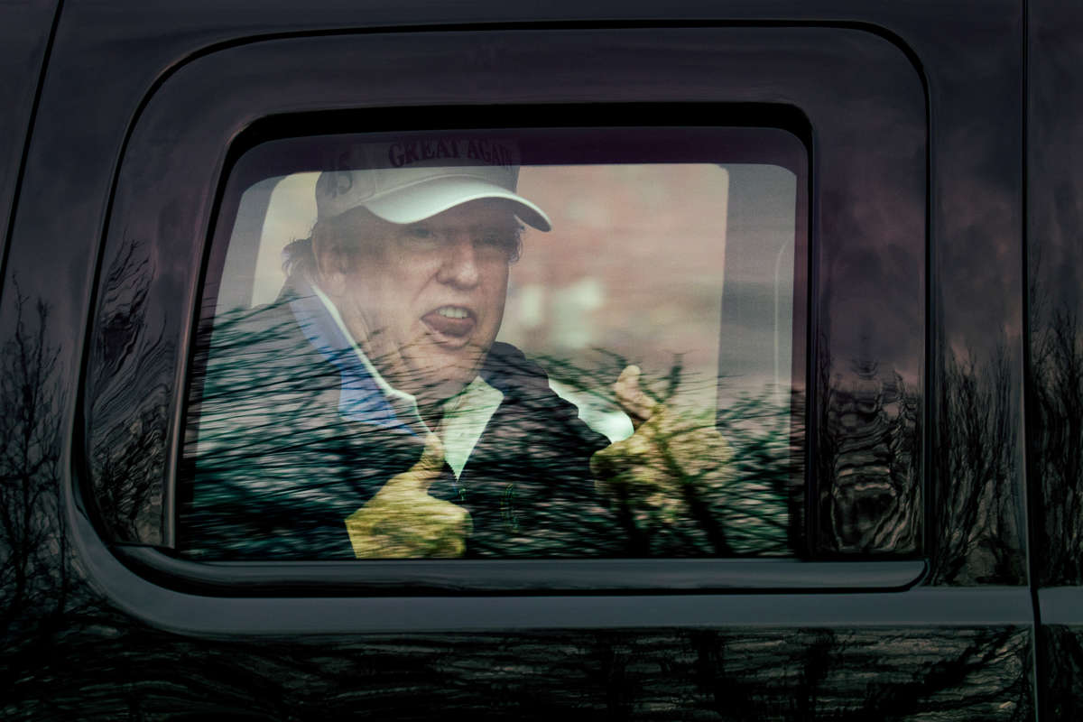 President Trump gives thumbs up to supporters from his motorcade after golfing at Trump National Golf Club on November 22, 2020, in Sterling, Virginia.