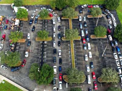Cars snake across a parking lot for food distribution
