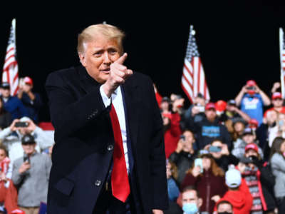 President Trump gestures after speaking during a rally to support Republican Senate candidates at Valdosta Regional Airport in Valdosta, Georgia, on December 5, 2020.