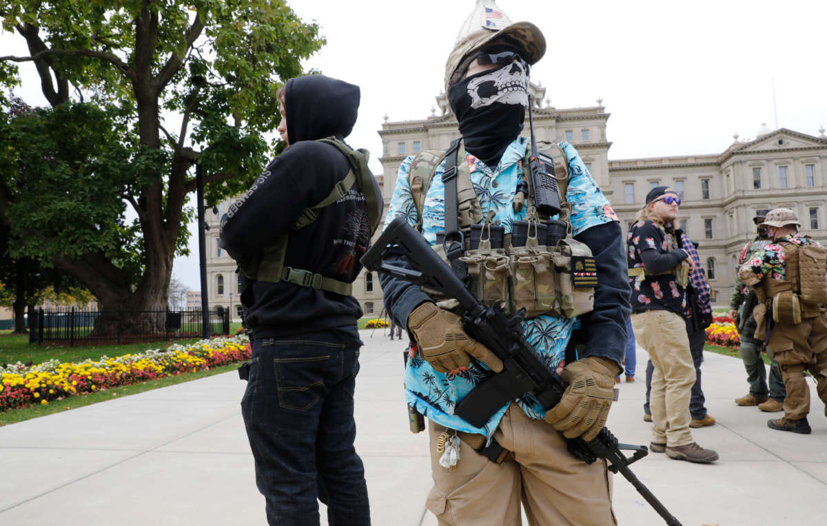 A group tied to the Boogaloo Bois holds a rally as they carry firearms at the Michigan State Capitol in Lansing, Michigan, on October 17, 2020.