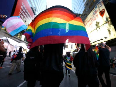 A protester holds a rainbow flag in support of transgender lives during a demonstration in Times Square against the police shooting of Roxanne Moore, a transgender woman.