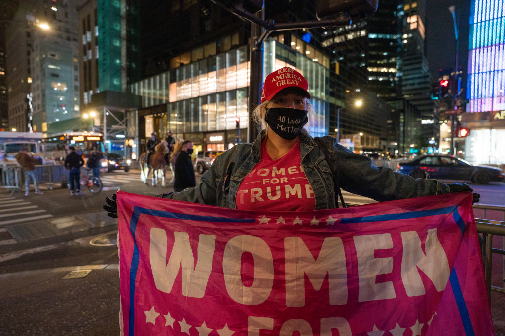 A supporter of Donald Trump holds a “Women for Trump” flag outside Trump Tower on November 3, 2020, in New York City.
