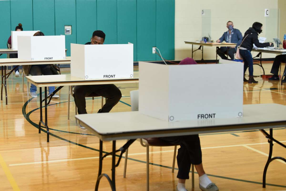 Voters cast their ballots at a polling station during early voting for the U.S. Presidential election on October 31, 2020, in Arlington, Virginia.