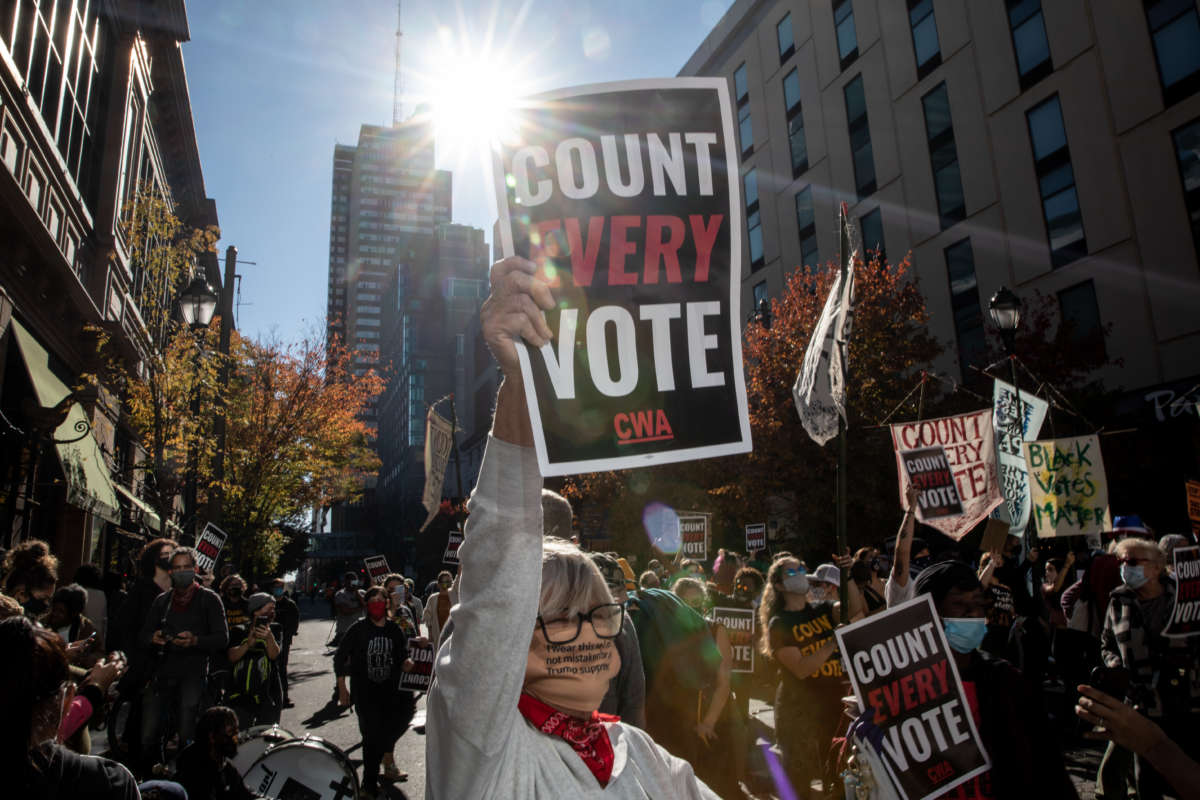 A protester in support of counting all votes holds a sign on November 5, 2020, in Philadelphia, Pennsylvania.