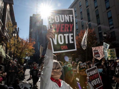 A protester in support of counting all votes holds a sign on November 5, 2020, in Philadelphia, Pennsylvania.
