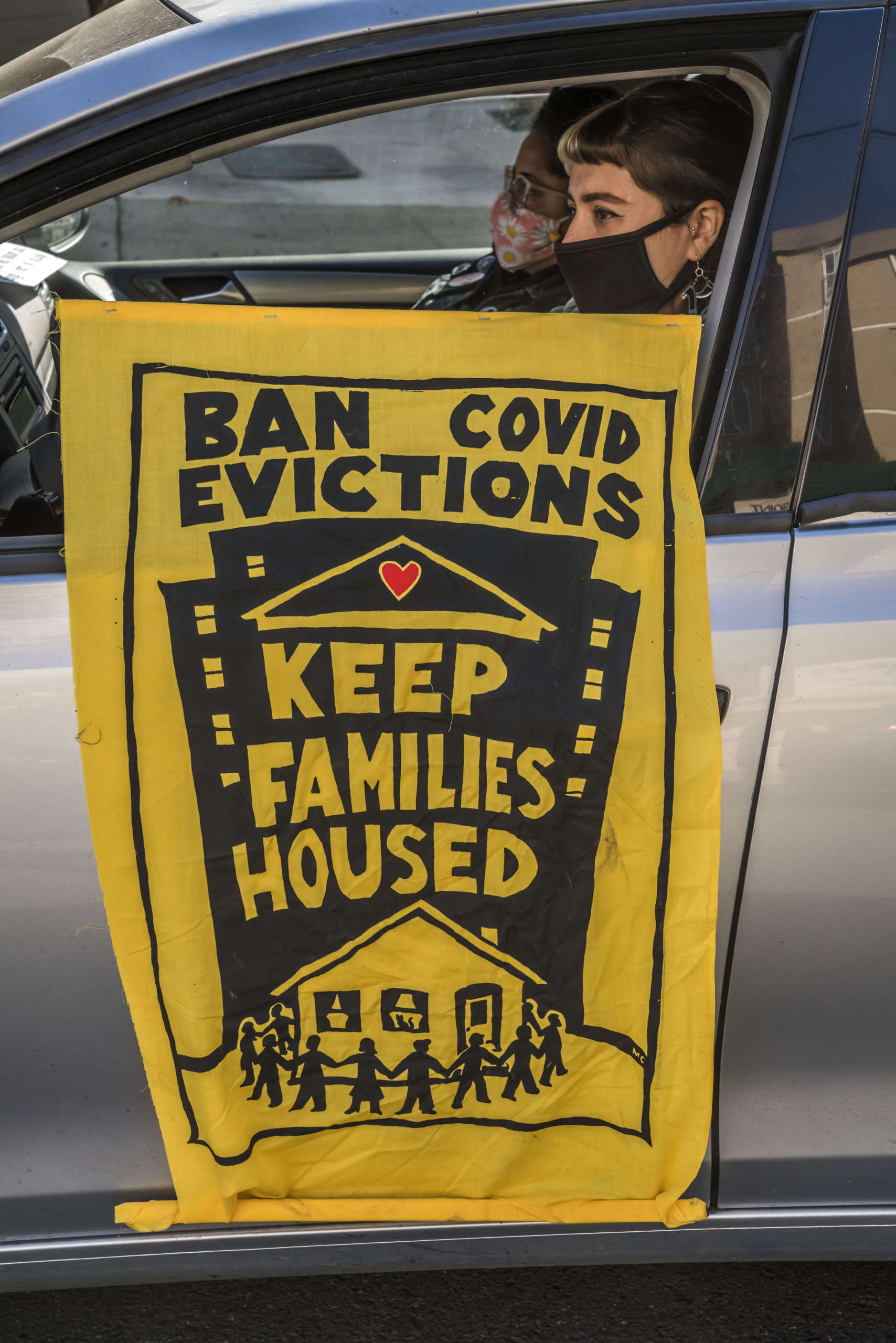 The banner produced by the caravan organizers taped to a car door.