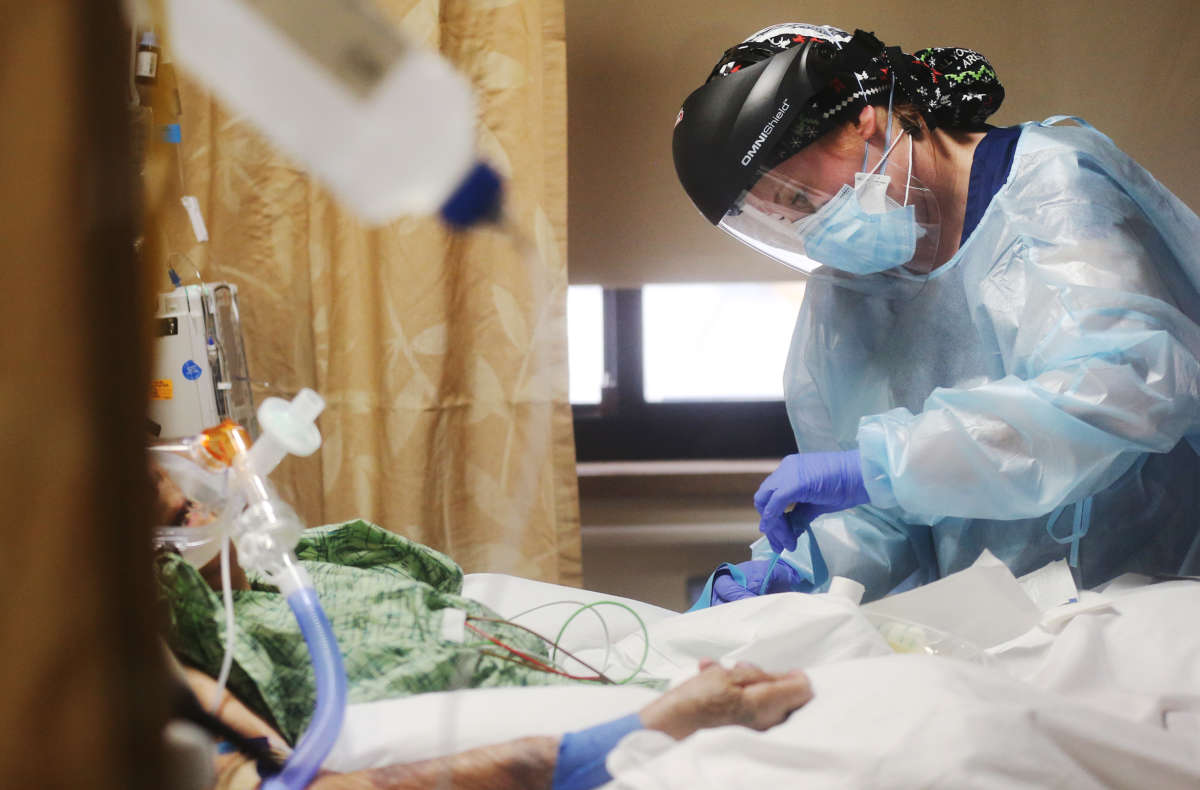 Registered nurse Katelyn Musslewhite cares for a COVID-19 patient in the Intensive Care Unit at Providence St. Mary Medical Center amid a surge in COVID-19 patients in Southern California on December 23, 2020, in Apple Valley, California.