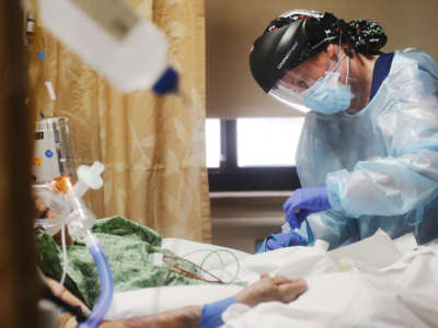 Registered nurse Katelyn Musslewhite cares for a COVID-19 patient in the Intensive Care Unit at Providence St. Mary Medical Center amid a surge in COVID-19 patients in Southern California on December 23, 2020, in Apple Valley, California.