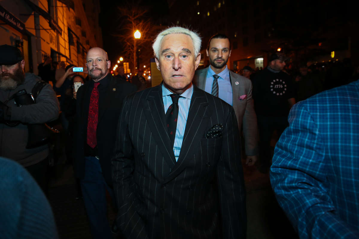 American political consultant Roger Stone walks through the crowd by his hotel as Trump supporters and Proud Boys held rally at night in Washington, D.C., United States on December 11, 2020.