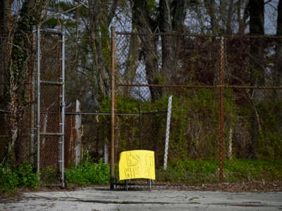 Sign informs parents who picked up items from the neighborhood public school to exit the premisses through the gate, in the Mt. Airy neighborhood of Philadelphia, Pennsylvania, on April 14, 2020.