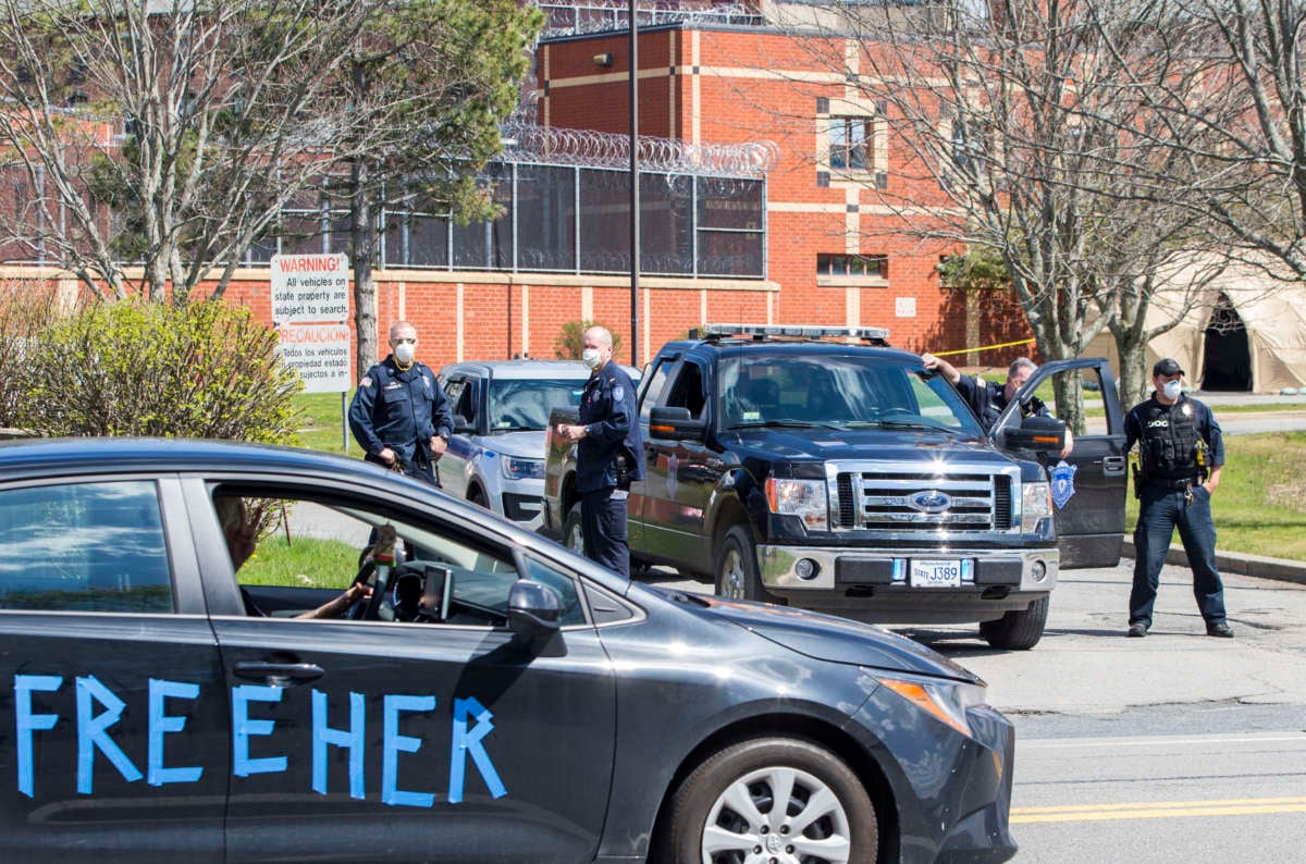 Prison staff block the entrances as a drive-by rally organized by Families for Justice as Healing moves around MCI Framingham, a women's prison hit hard by the coronavirus, in Framingham, MA on May 3, 2020.
