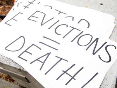 Signs are seen during a protest to cancel rent and avoid evictions in front of the court house amid Coronavirus pandemic on August 21, 2020, in Los Angeles, California.