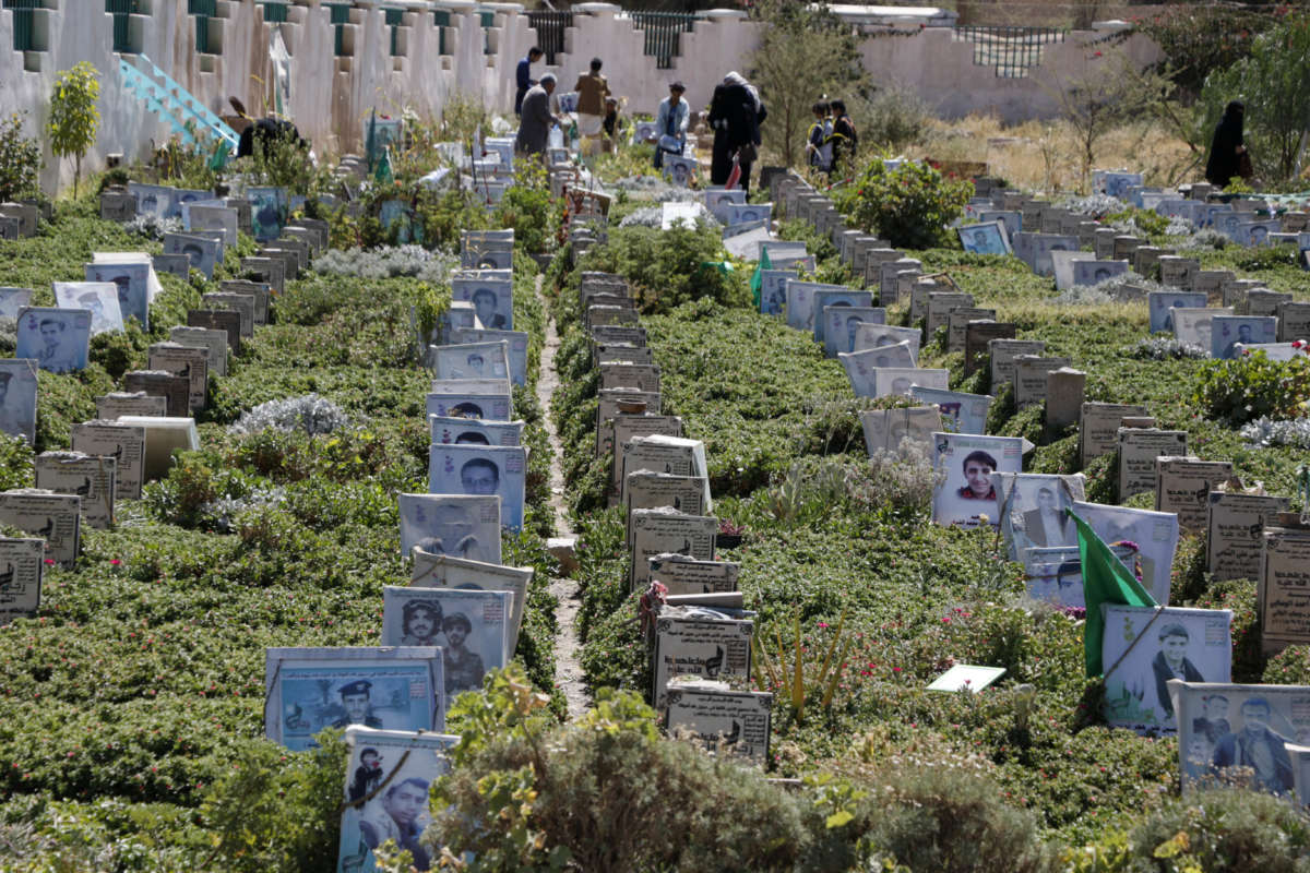 Yemeni relatives visit graves of their relatives who were killed in the ongoing Yemeni civil war at a cemetery on November 6, 2020 in Sana'a, Yemen.