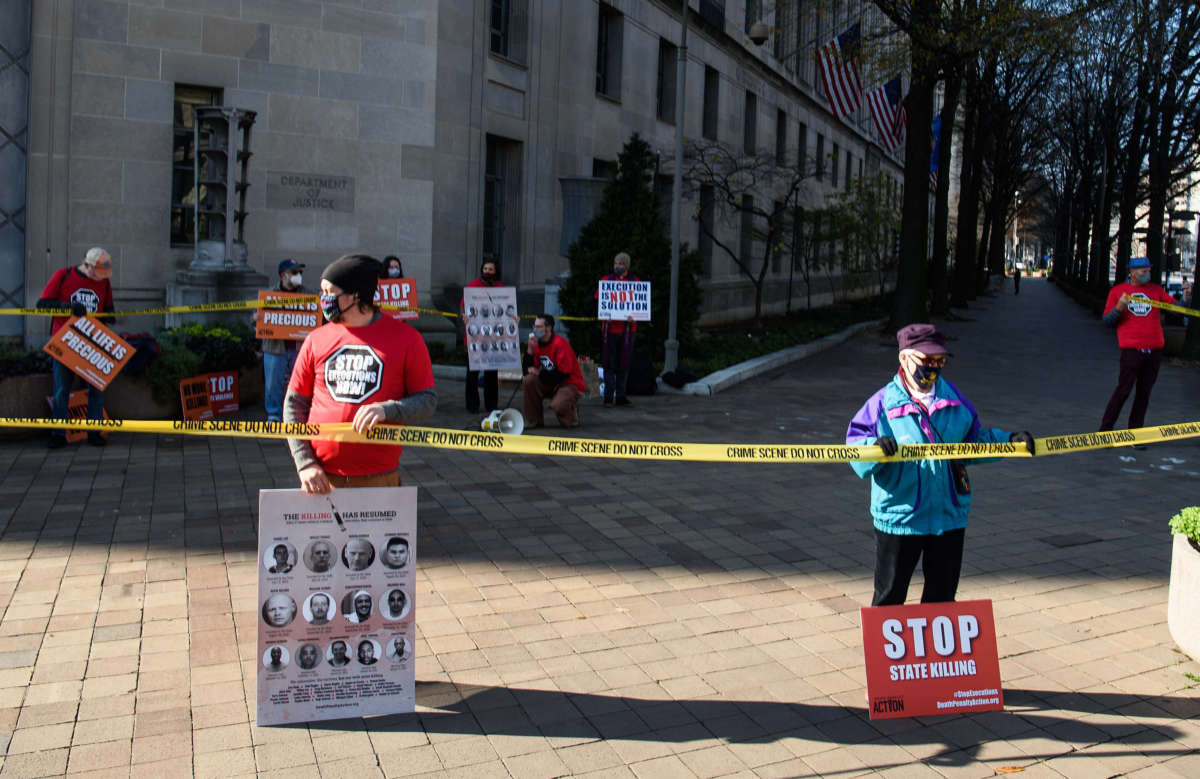 Demonstrators protest federal executions of death row inmates in front of the U.S. Justice Department in Washington, D.C., on December 10, 2020.