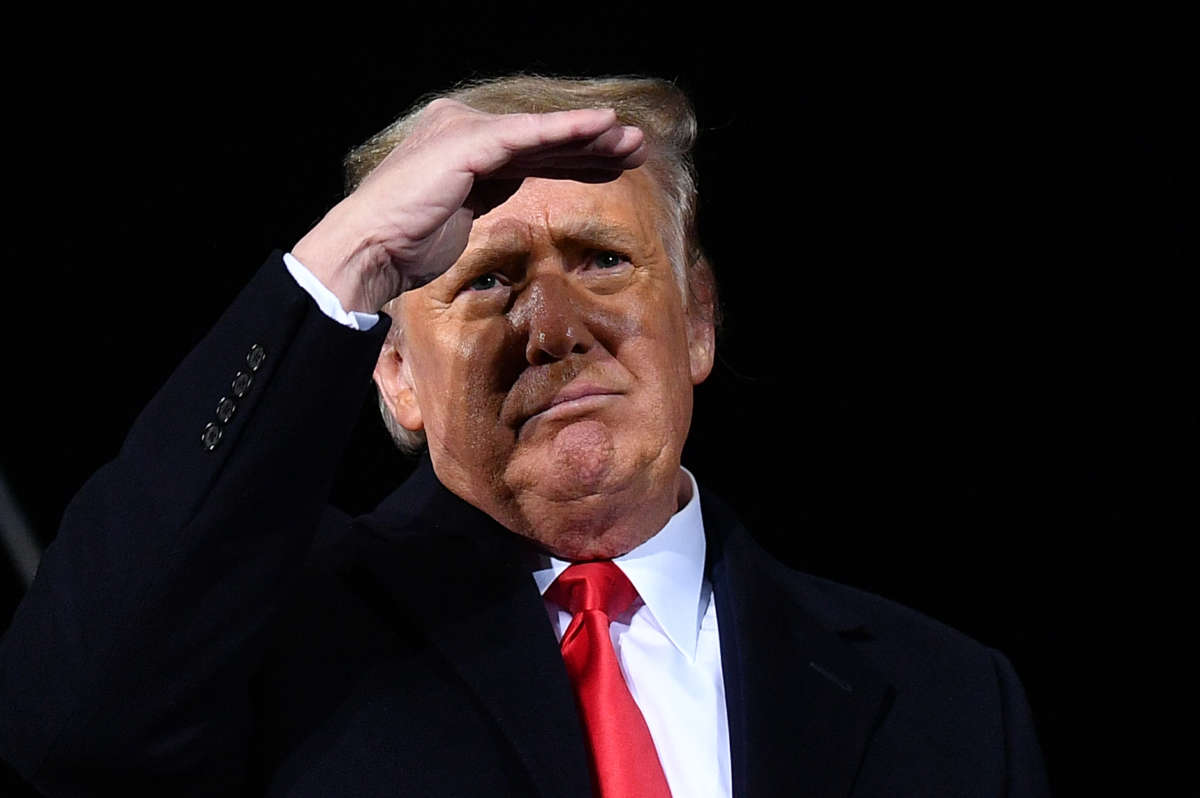 Trump shields his eyes