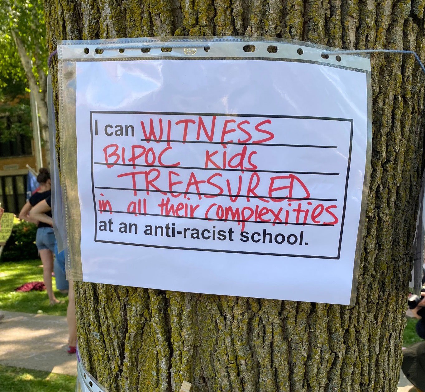 A parent’s vision for an antiracist school hangs on a tree in front of an elementary school during a Day of Solidarity action in Madison, Wisconsin.