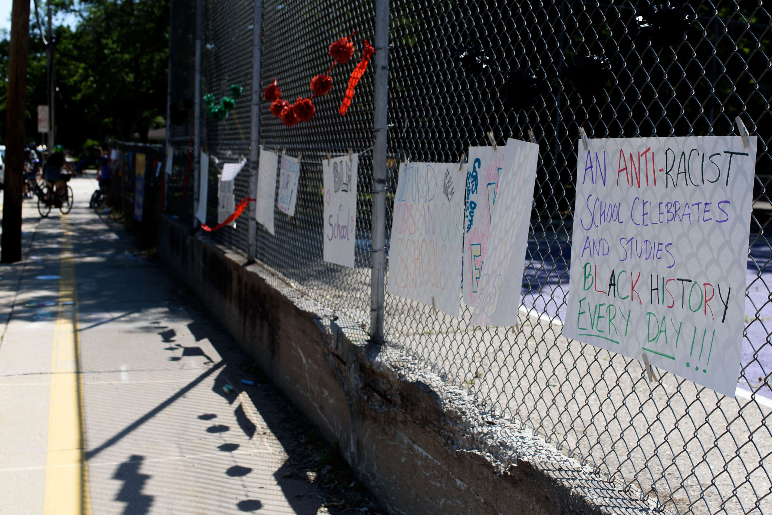 Youth and families’ visions for an antiracist school hang on a fence at an elementary school during a Day of Solidarity action in Madison, Wisconsin.