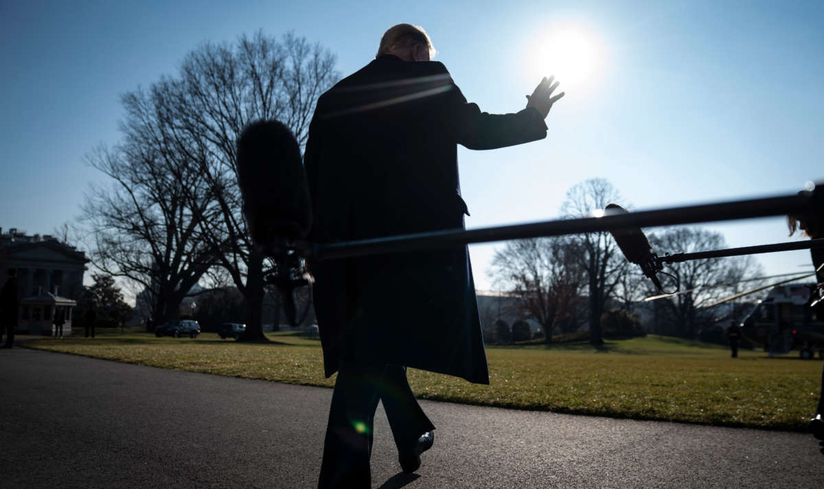 President Trump stops to talk to reporters as he walks to board Marine One and depart from the South Lawn at the White House on January 12, 2021, in Washington, D.C.