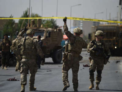 U.S. soldiers arrives at the site of a car bomb attack that targeted a NATO coalition convoy in Kabul on September 24, 2017.
