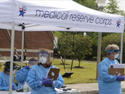 Virginia National Guard Soldiers and Airmen assist with a drive-thru COVID-19 testing site run by the Virginia Department of Health Eastern Shore Health District on May 8, 2020, at the Eastern Shore Community College in Melfa, Virginia.