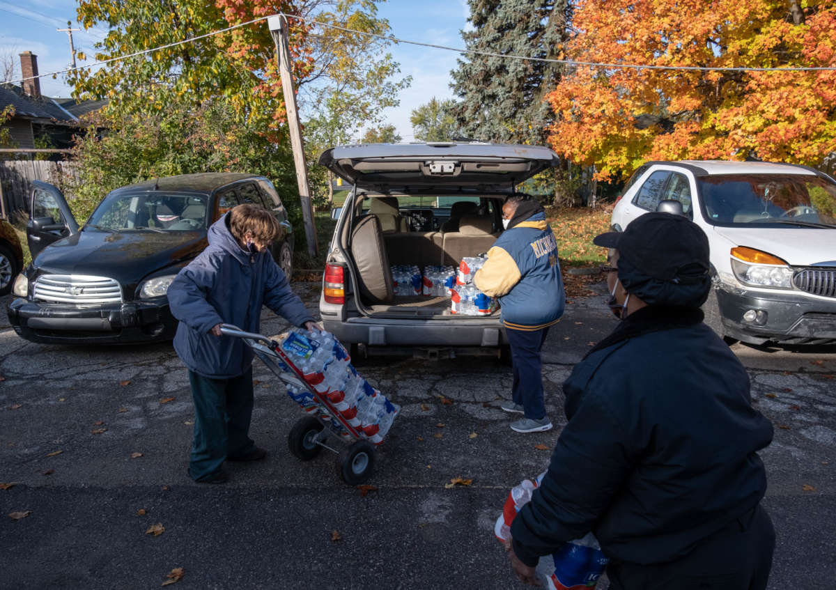 Volunteers help distribute water at the community center at the Asbury United Methodist Church in Flint, Michigan, on October 20, 2020.