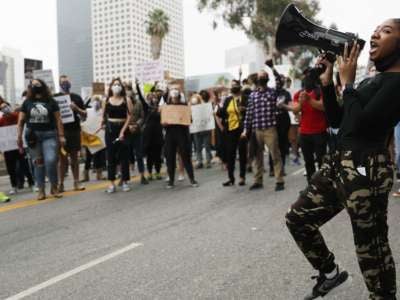 Black Lives Matter-Los Angeles supporters protest outside the Unified School District headquarters calling on the board of education to defund school police on June 23, 2020, in Los Angeles, California.